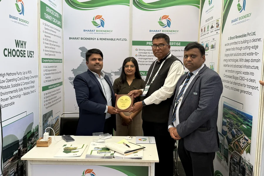 Bharat Bioenergy & Renewable team receiving an award plaque at their exhibition booth